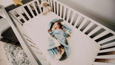 Safe environment for your newborn with baby sleeping on back in empty crib