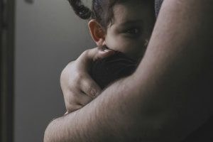 Parent comforting baby crying at night for no reason