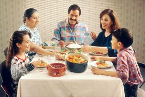 Phone free teens and family enjoying meaningful dinner conversation together