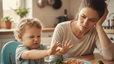 Frustrated toddler won't eat anything from colorful dinner plate while parent watches concerned