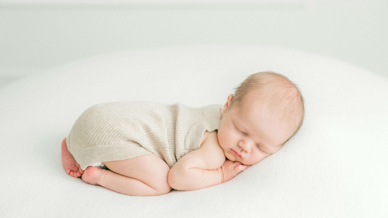 Newborn in crib illustrating this baby sleep guide