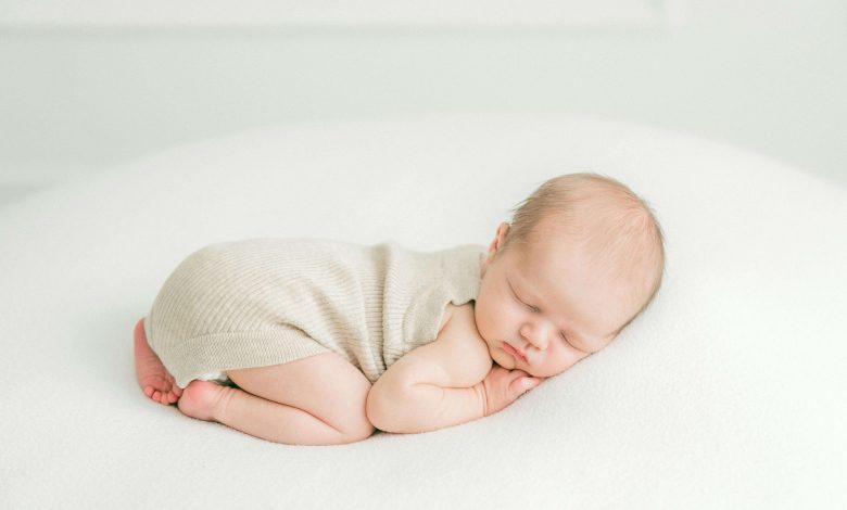 Newborn in crib illustrating this baby sleep guide