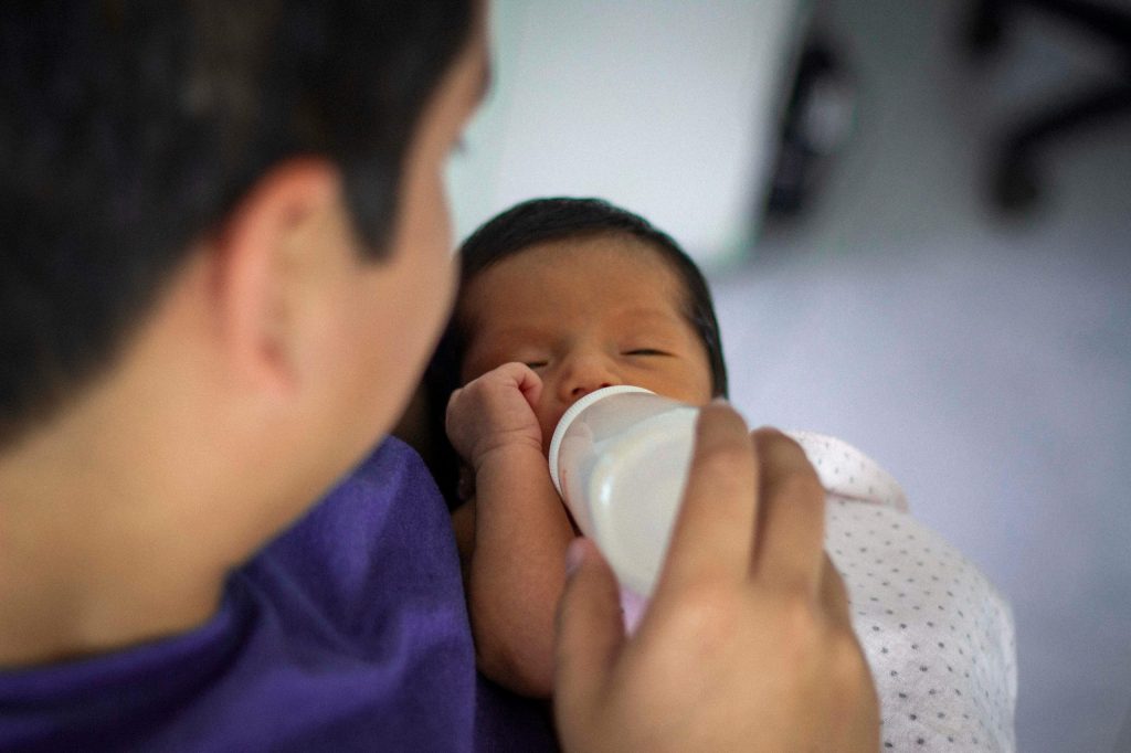 Newborn wake windows by age showing a newborn awake briefly during feeding time