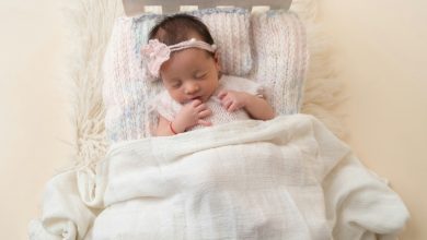 Newborn baby sleeping peacefully in white crib — newborn sleep schedule guide