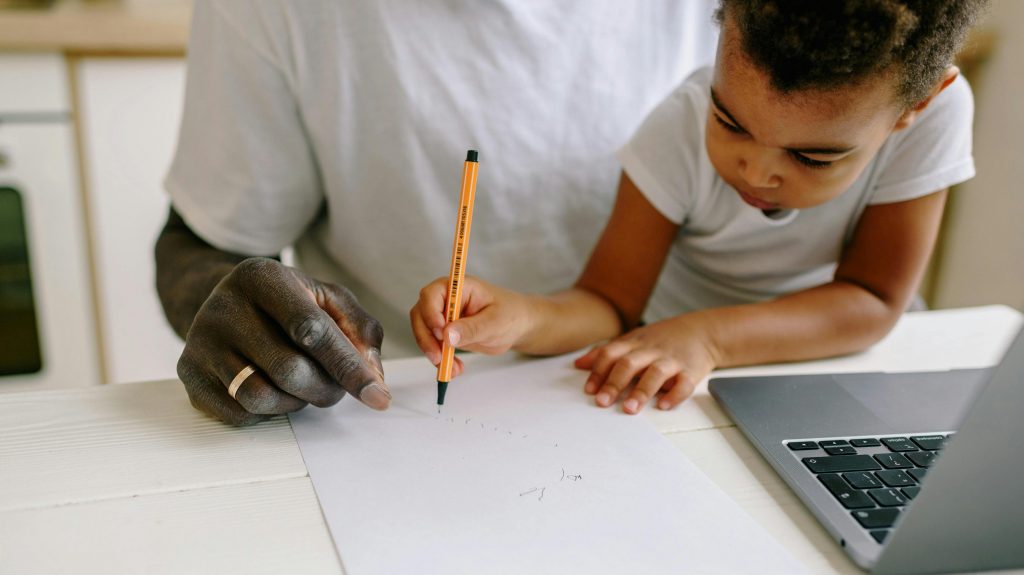 A parent guiding their child while discussing ChatGPT for homework at home in a supportive learning environment.