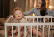 Parent comforting a toddler during a 2 year old sleep regression at bedtime