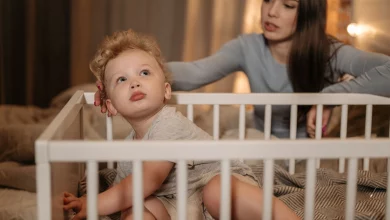 Parent comforting a toddler during a 2 year old sleep regression at bedtime