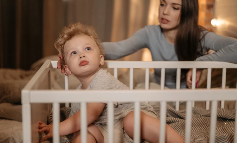 Parent comforting a toddler during a 2 year old sleep regression at bedtime