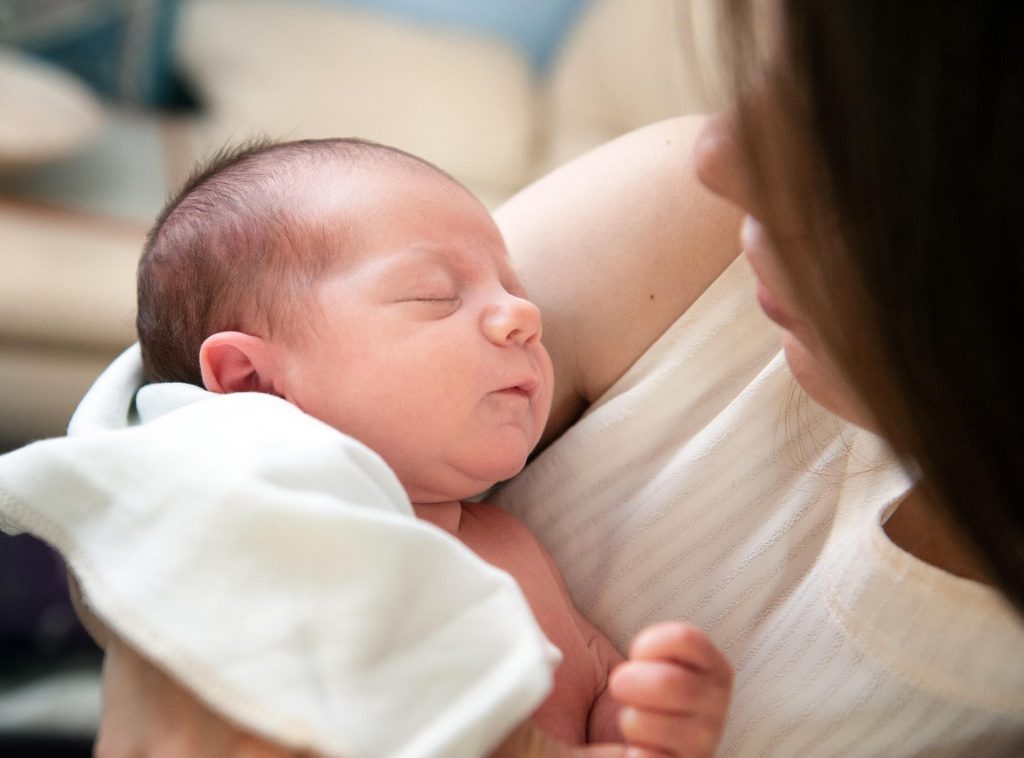 Parent using pink noise baby sleep techniques during bedtime.