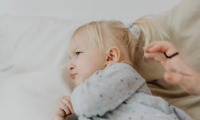 Toddler behavior guide showing a parent calmly helping a toddler during a tantrum