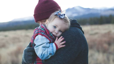 Toddler hitting and biting behavior as a parent calmly comforts an upset toddler during a tantrum