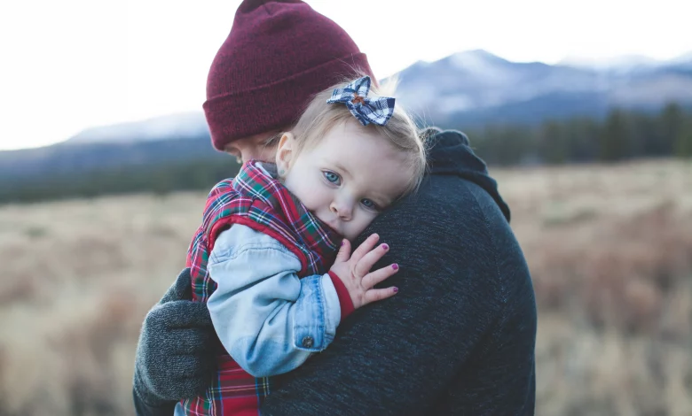 Toddler hitting and biting behavior as a parent calmly comforts an upset toddler during a tantrum