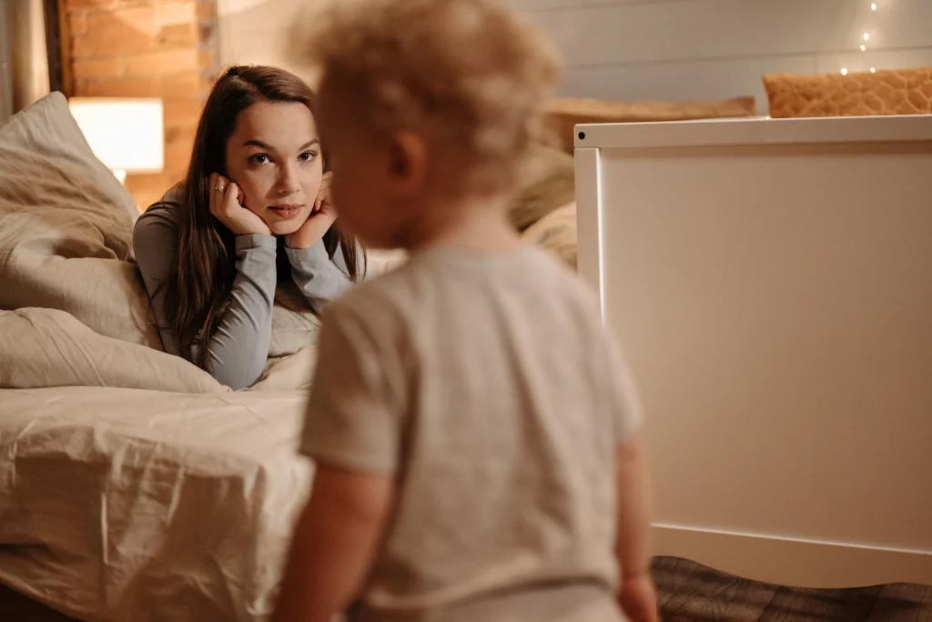 Parent speaking calmly to a toddler won't listen during playtime