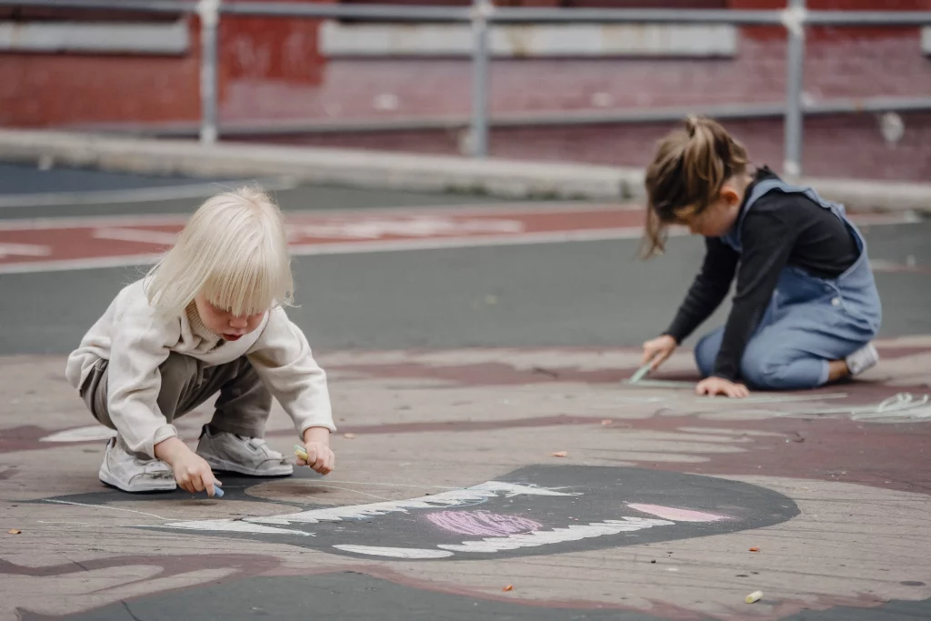 toddler doing chalk and nature-based outdoor activities