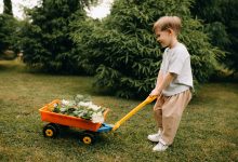 toddler enjoying simple toddler outdoor activities in a garden