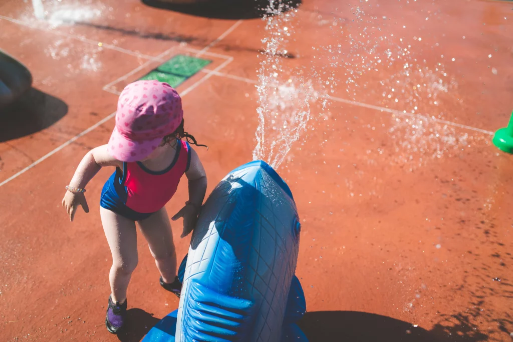 toddler enjoying water painting and sensory outdoor play