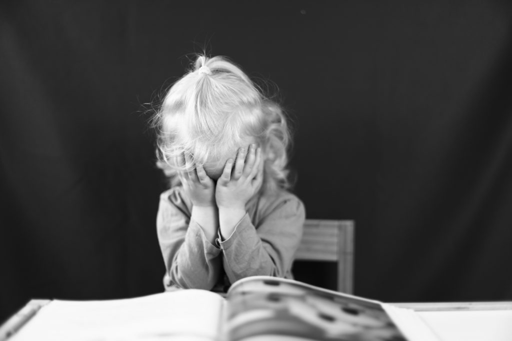 Toddler experiencing frustration during a tantrum while a parent stays calm
