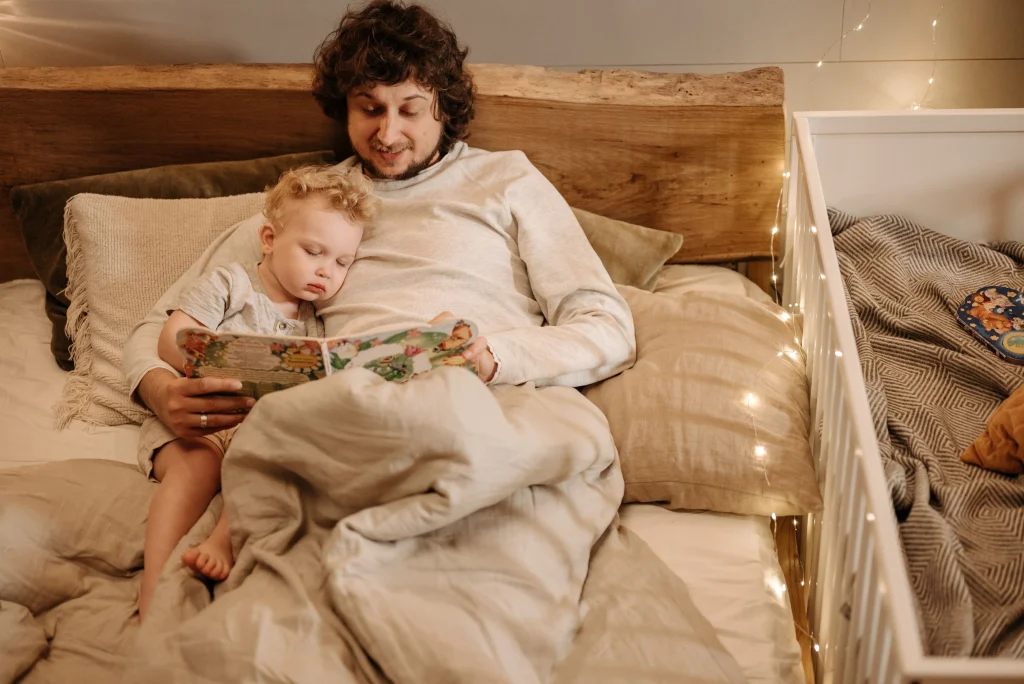 Father reads a bedtime story with his toddler during a regular bonding routine