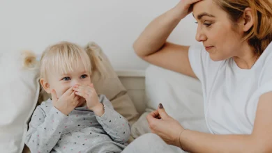 Toddler laughing while mother calmly sets a boundary during a parenting moment